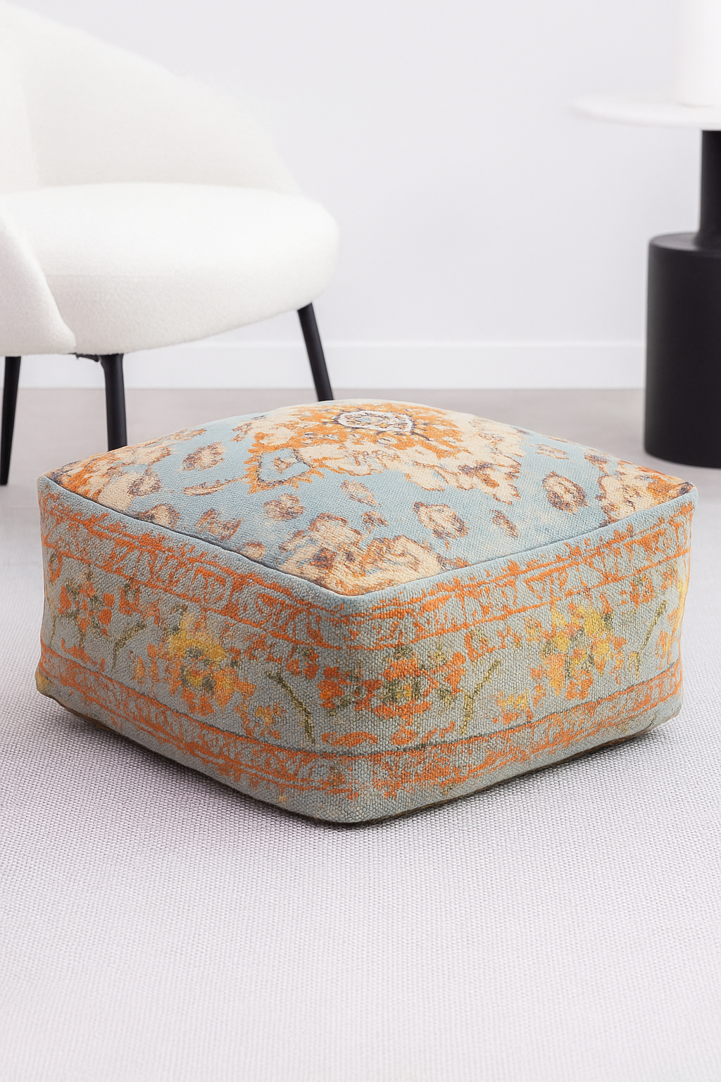 Decorative ottoman with floral pattern on a light background