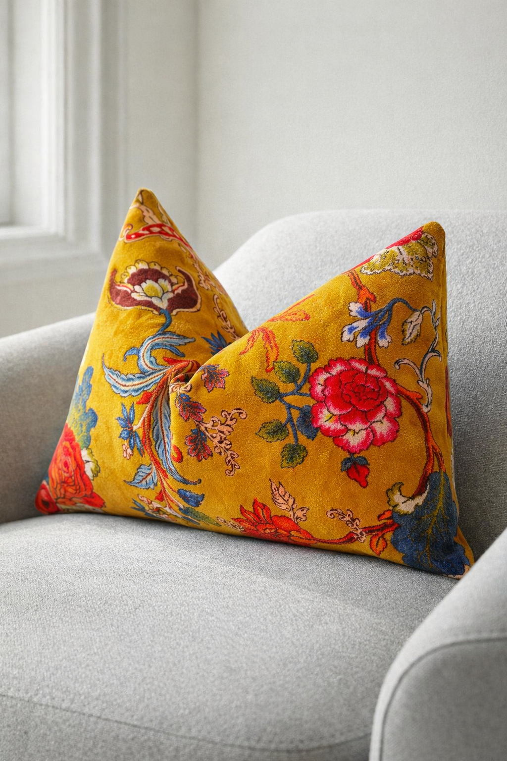 Colorful floral-patterned pillows on a gray sofa