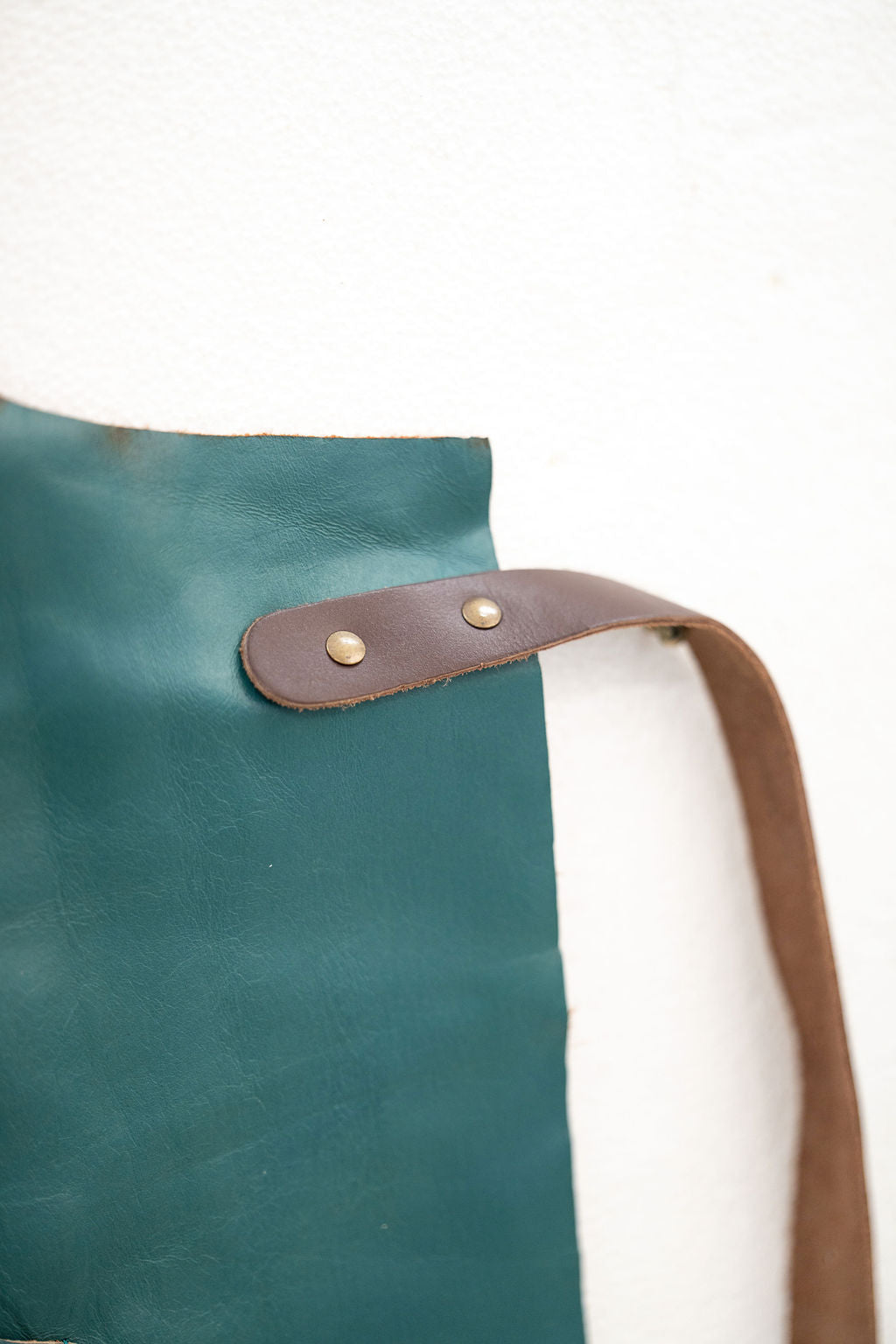 Professional ocean teal leather apron worn in workshop environment