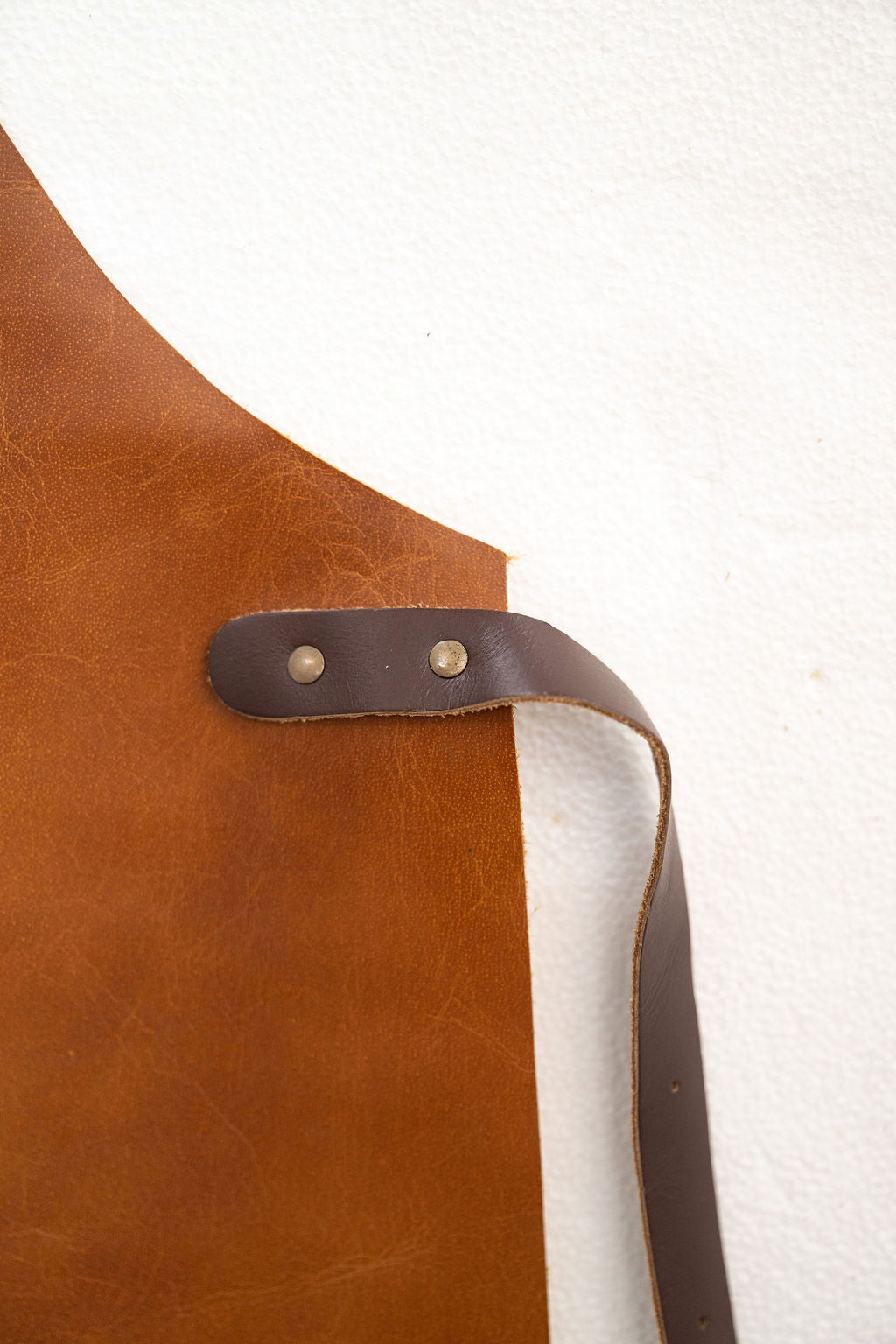 Professional saddle brown leather apron worn in workshop environment