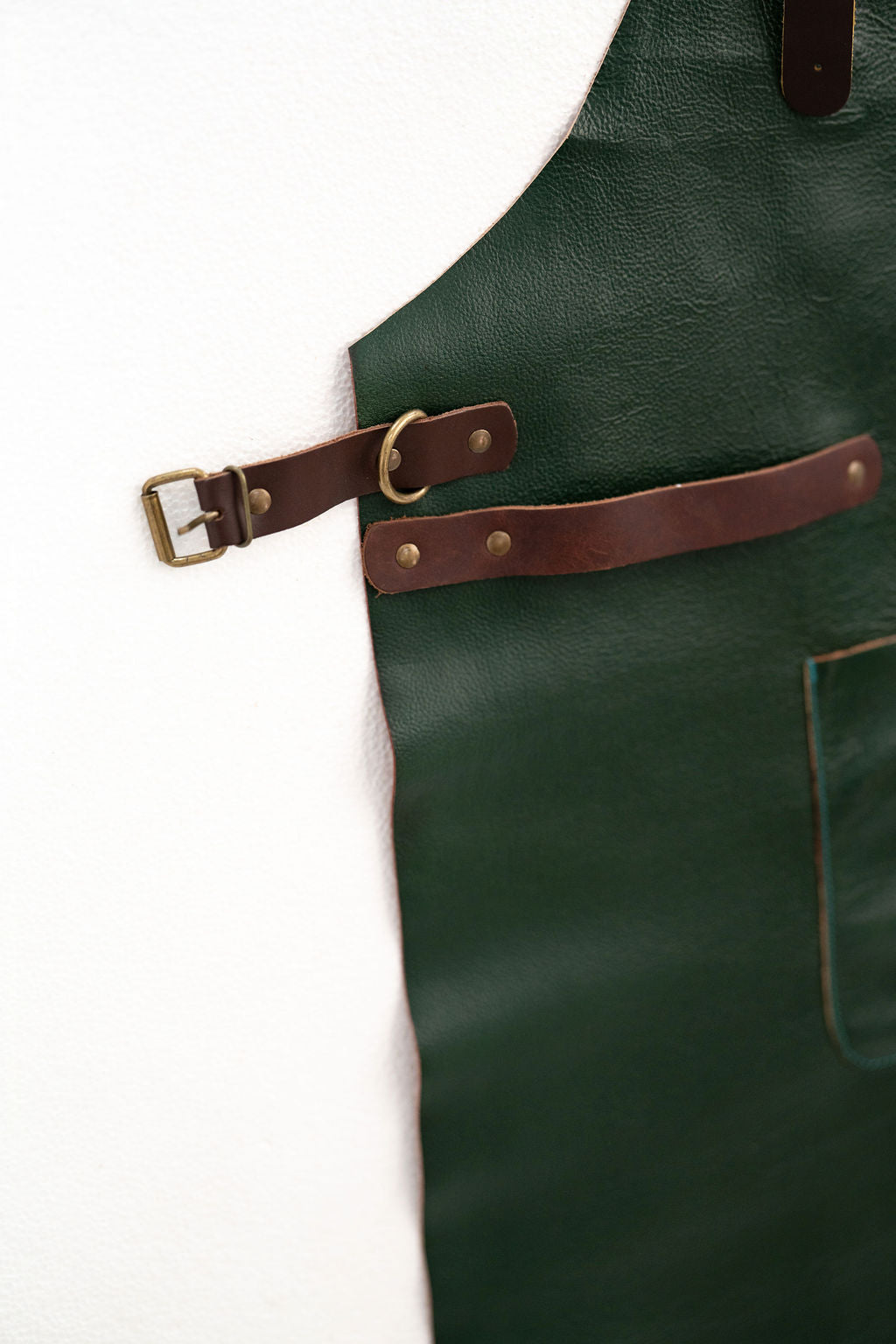 Close-up of forest green leather apron showing premium texture detail