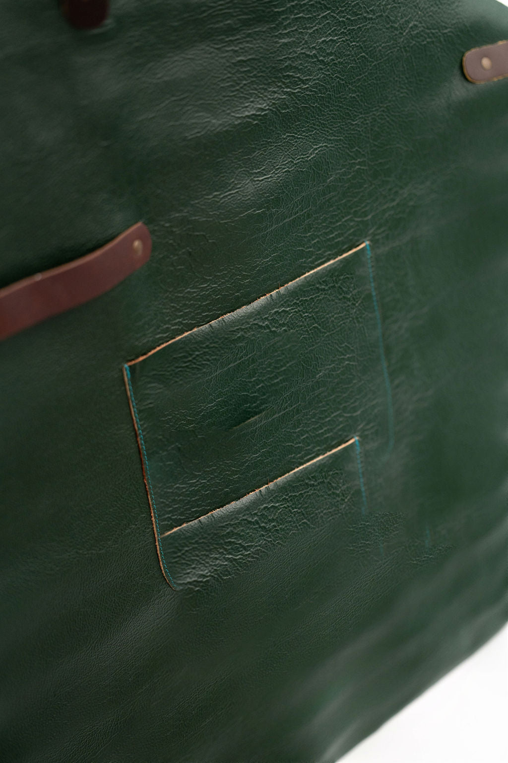 Back view of forest green leather apron with cross adjustable straps