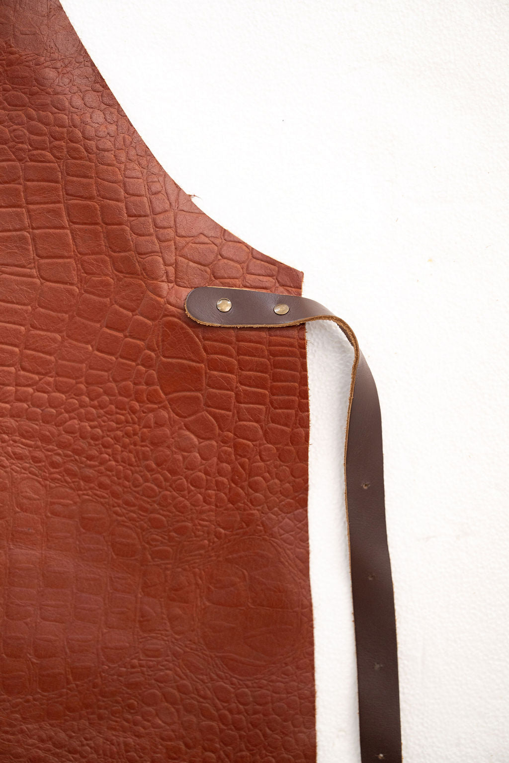 Back view of croc embossed leather apron with adjustable straps