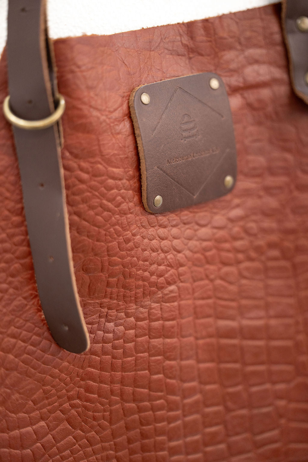 Professional croc leather apron worn by craftsman in workshop