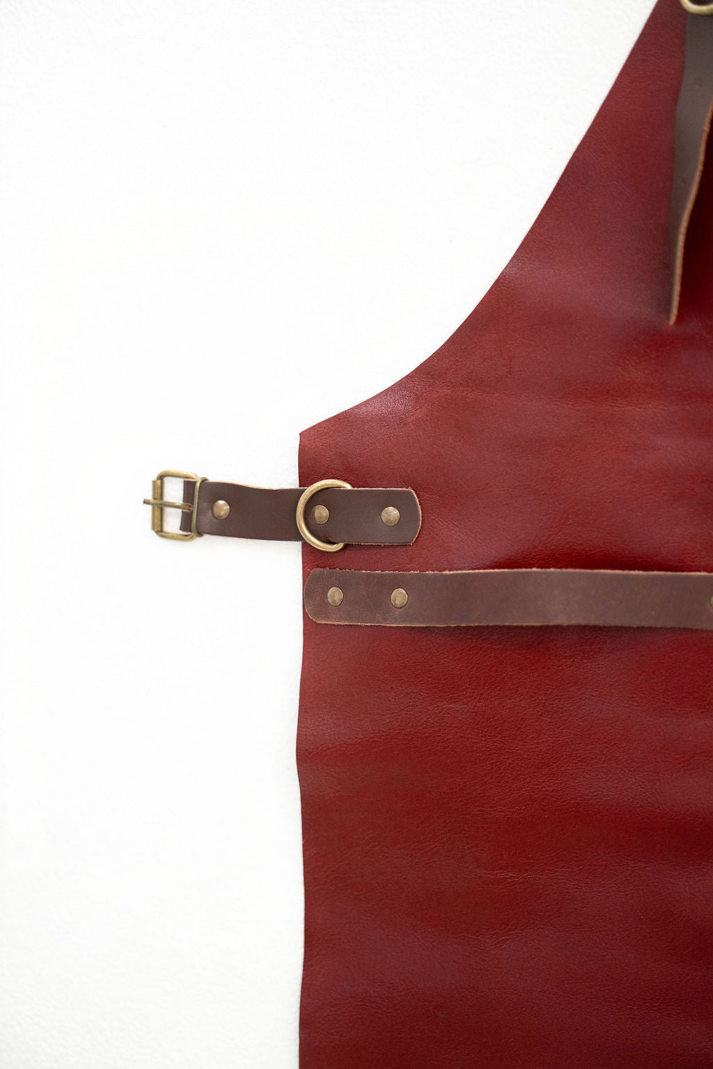 Red leather apron close-up showing smooth texture and finish