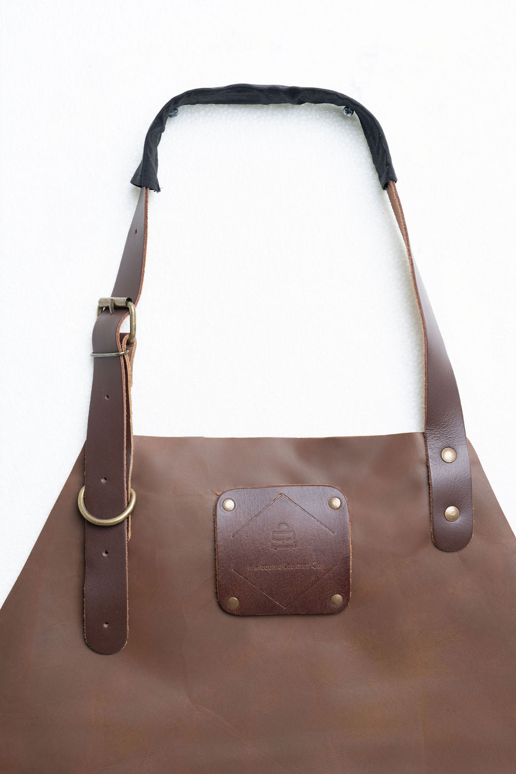 Full-length leather apron back view showing adjustable cross straps