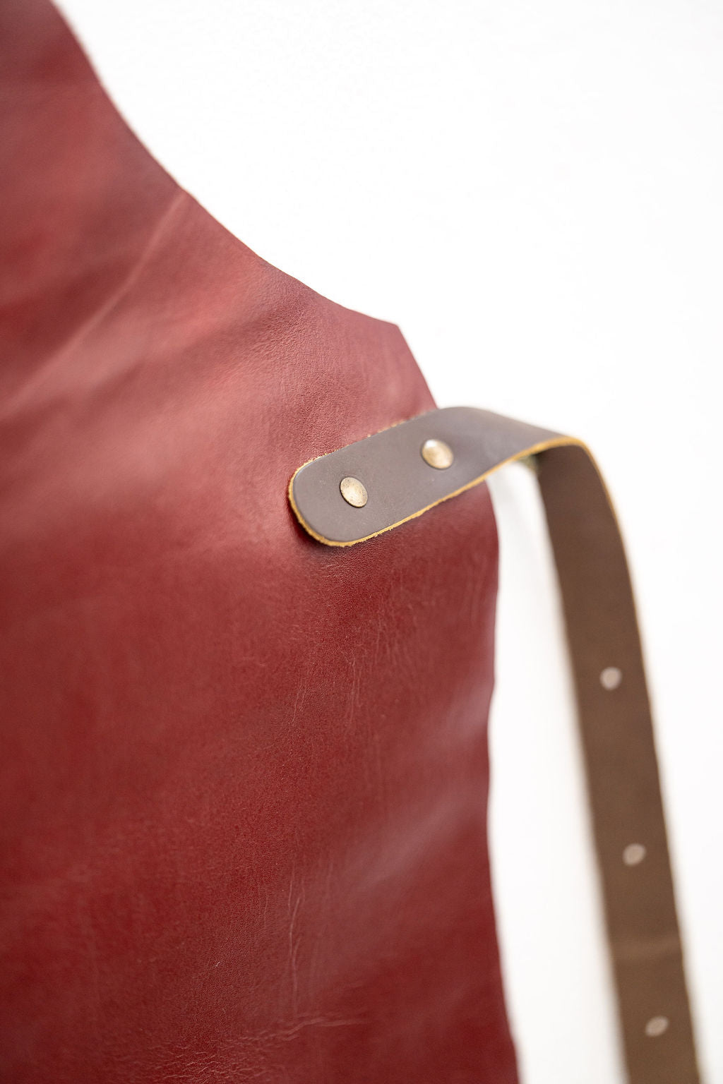 Stylish red leather apron worn by chef in modern kitchen