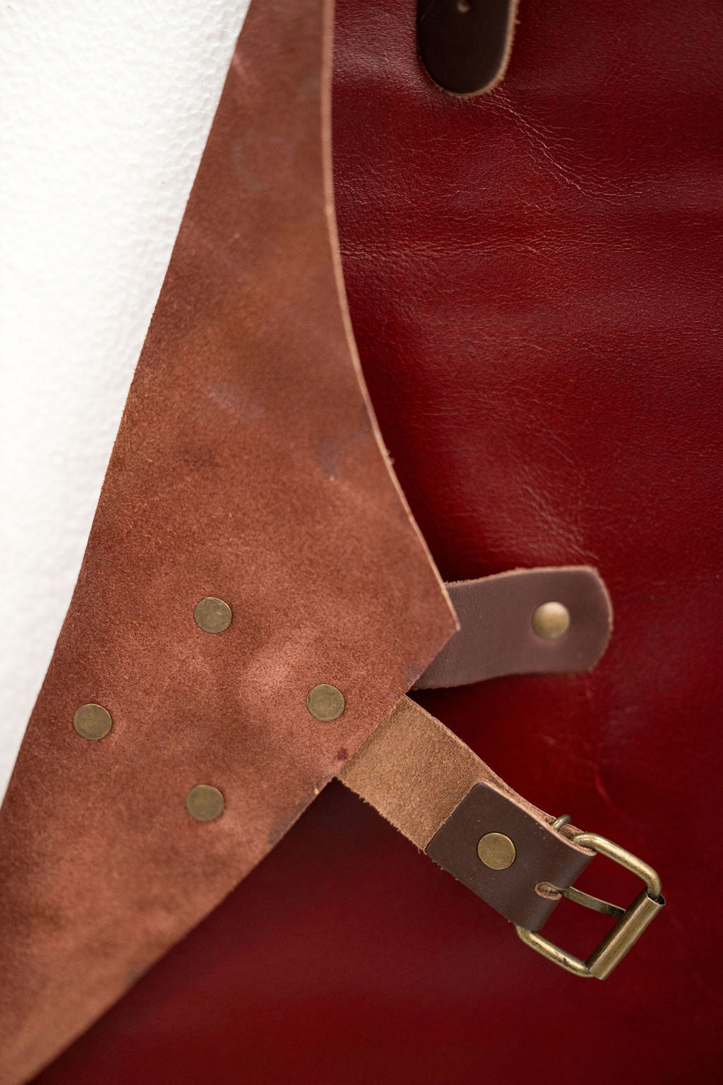 Red leather apron lifestyle shot in workshop environment