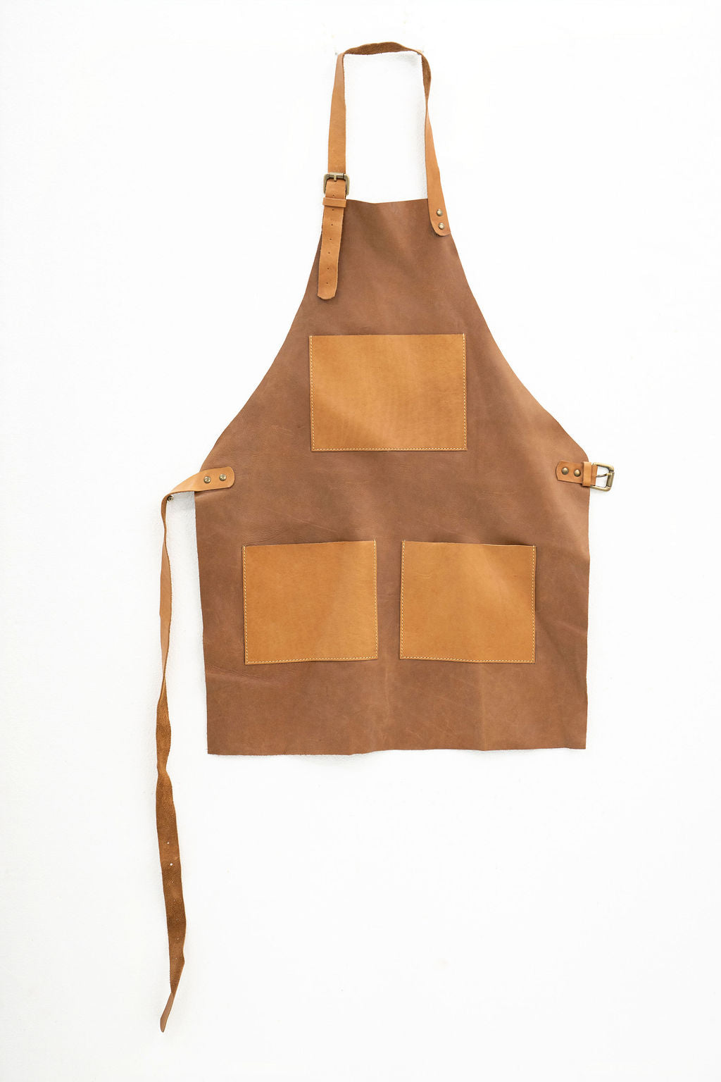 Lightweight tan leather apron with pockets for kitchen and workshop