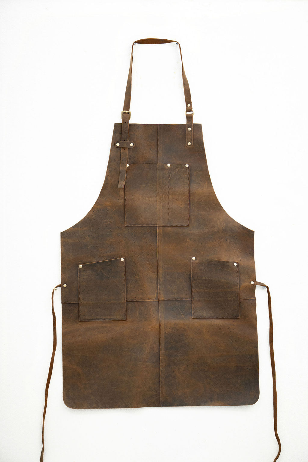 Durable brown leather apron with front pockets for barber and artisan work