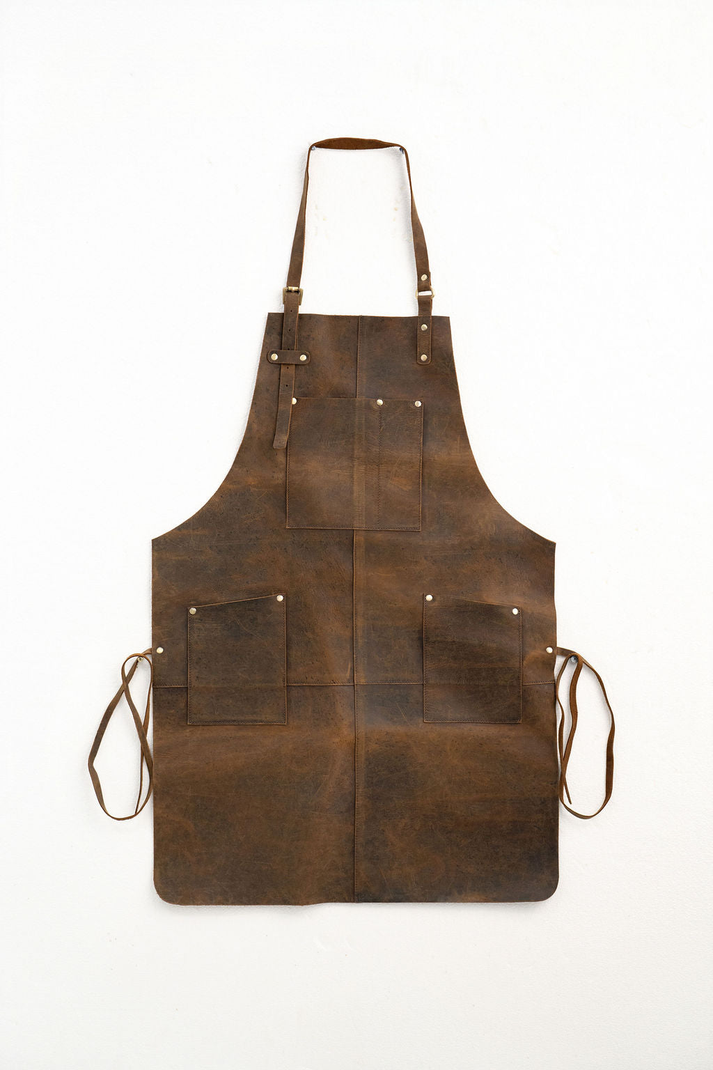 Vintage style leather apron brown with strong stitching and storage pockets