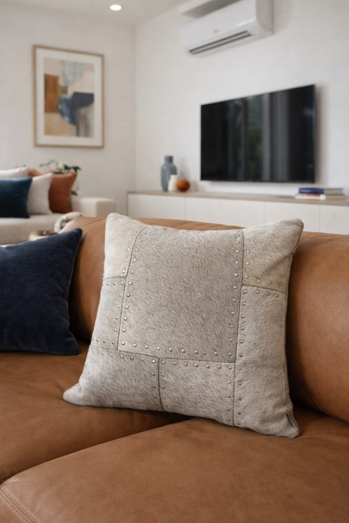 Premium 40x40 studded cowhide leather cushion cover with patchwork detail for stylish living spaces